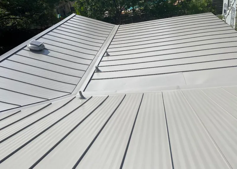 Solar attic fan installed on a metal roof for Roof Ventilation in Yorkville